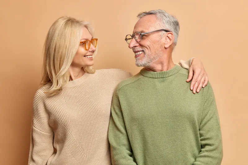 A smiling couple stands closely together in Florida
